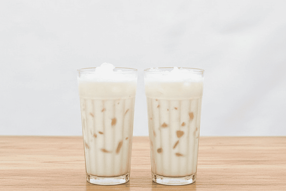 A refreshing bowl of che dua dam, where silky coconut milk, crunchy jelly, and shredded young coconut come together in a sweet